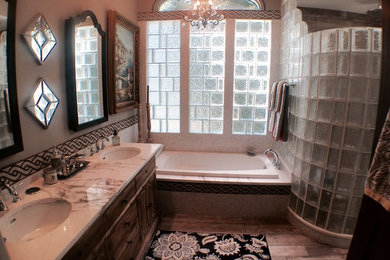 Traditional bathroom in Richmond with furniture-like cabinets, distressed cabinets, black and white tile, marble benchtops, a drop-in tub, a corner shower, porcelain tile, beige walls, porcelain floors and an undermount sink.