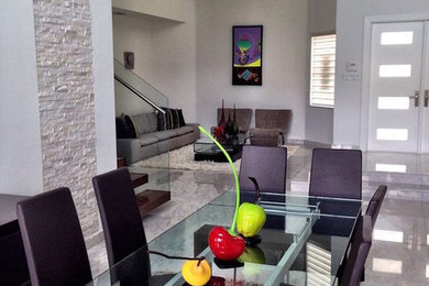 Large elegant dining room photo in Miami with white walls