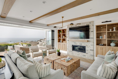 Living room - coastal light wood floor, exposed beam and shiplap wall living room idea in Orange County