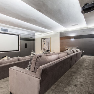 Huge cottage chic enclosed carpeted and gray floor home theater photo in Las Vegas with gray walls and a projector screen