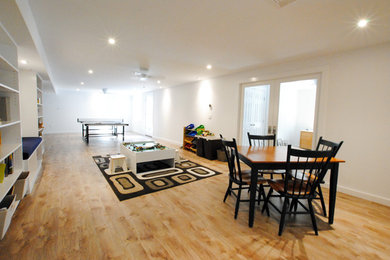 Basement - mid-sized traditional walk-out vinyl floor and beige floor basement idea in New York with white walls