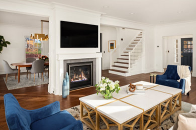 Inspiration for a transitional open concept dark wood floor and brown floor living room remodel in Seattle with white walls, a two-sided fireplace, a tile fireplace and a wall-mounted tv