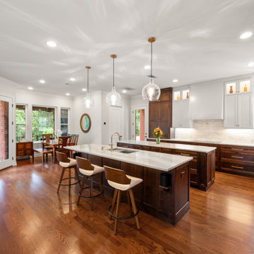 Spacious kitchen layout with walnut wood grain double islands and oak floors