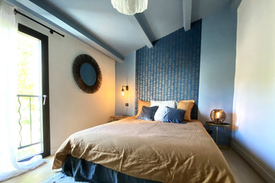 Cette photo montre une chambre mansardée ou avec mezzanine moderne de taille moyenne avec un mur bleu, parquet clair, poutres apparentes et du papier peint.