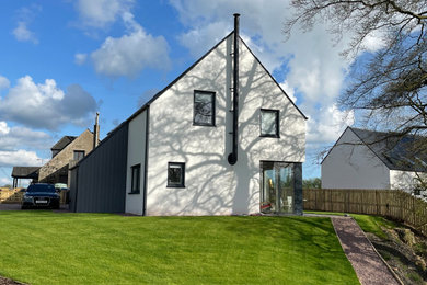 Inspiration for a large and white contemporary two floor render and front detached house in Glasgow with a pitched roof, a tiled roof and a grey roof.