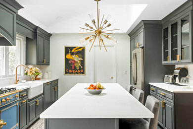 This is an example of a large contemporary galley eat-in kitchen in New York with a farmhouse sink, glass-front cabinets, grey cabinets, solid surface benchtops, stainless steel appliances, ceramic floors, with island, grey floor and white benchtop.