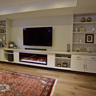 Photo of a traditional basement in Toronto with grey walls, vinyl flooring, a standard fireplace, a wooden fireplace surround and brown floors.