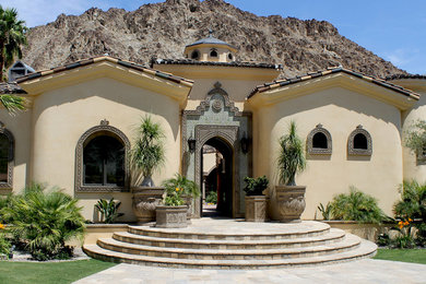 Inspiration for a large mediterranean one-storey stucco beige exterior in San Diego.