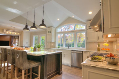 Inspiration for a large transitional l-shaped ceramic tile and brown floor eat-in kitchen remodel in New York with shaker cabinets, white cabinets, granite countertops, beige backsplash, wood backsplash, stainless steel appliances, an island and beige countertops