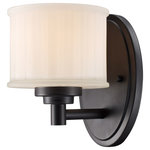 Trans Globe Lighting - Cahill Sconce, 5.75" - The Cahill Collection exhibits a unique wall sconce that is perfect for adding supplemental lighting to any interior wall space. The Transitional tone allows the wall sconce to stand out as both functional and decorative as it lights up any interior setting. Cool sleek sophistication defines this single light wall sconce. Understated mounting hardware complements the White Frost glass drum shade.