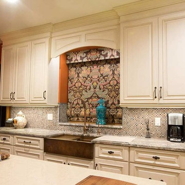Off-white kitchen with copper farmhouse workstation sink