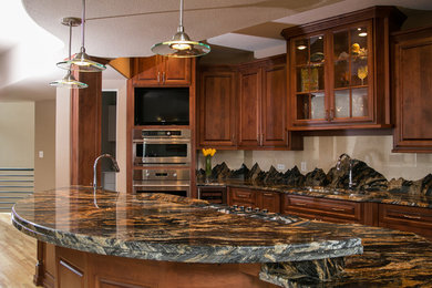 Example of a minimalist kitchen design in Denver with stainless steel appliances