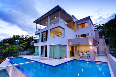 This is an example of a large contemporary three-storey concrete white exterior in Brisbane.