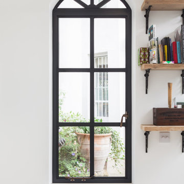 Curved steel window with brass ironmongery