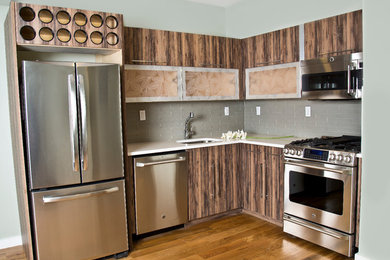 Example of a mid-sized minimalist l-shaped medium tone wood floor and brown floor eat-in kitchen design in New York with an undermount sink, glass-front cabinets, medium tone wood cabinets, quartz countertops, gray backsplash, glass tile backsplash, stainless steel appliances and no island