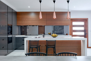 This is an example of a mid-sized modern eat-in kitchen in Adelaide with a single-bowl sink, flat-panel cabinets, grey cabinets, quartz benchtops, glass sheet splashback, black appliances, ceramic floors, with island and white floor.