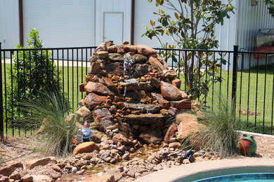 Pool fountain - mid-sized contemporary backyard custom-shaped aboveground pool fountain idea in Austin