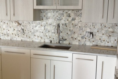 Small trendy l-shaped open concept kitchen photo in Other with flat-panel cabinets, white cabinets and an island