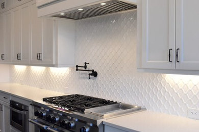 Inspiration for a mid-sized timeless dark wood floor enclosed kitchen remodel in Atlanta with recessed-panel cabinets, white cabinets, quartz countertops, white backsplash, ceramic backsplash, stainless steel appliances and no island
