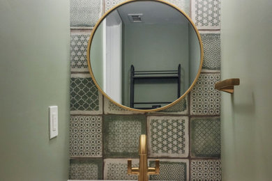 Photo of a medium sized retro cloakroom in DC Metro with freestanding cabinets, green cabinets, a two-piece toilet, green tiles, porcelain tiles, green walls, porcelain flooring, an integrated sink, engineered stone worktops, green floors, white worktops and a built in vanity unit.