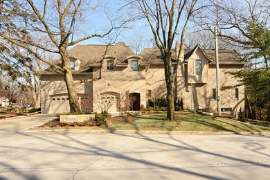 Large transitional beige two-story mixed siding exterior home idea in Toronto