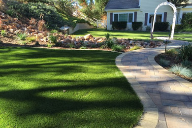 Photo of a large craftsman partial sun backyard landscaping in San Diego.