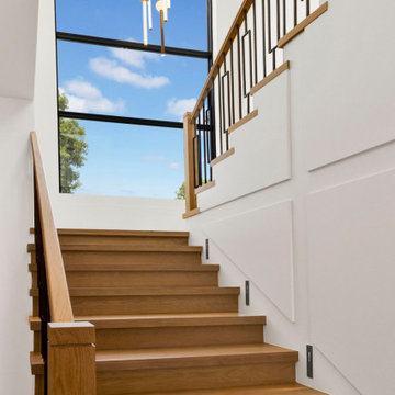 White oak staircase with a full-height landing window