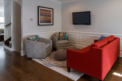 Foto de sala de estar abierta contemporánea de tamaño medio con paredes grises, suelo de madera en tonos medios y televisor colgado en la pared