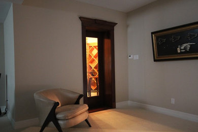 Example of a transitional wine cellar design in Ottawa
