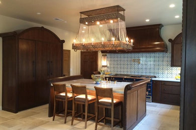 Eat-in kitchen - mid-sized traditional u-shaped ceramic tile eat-in kitchen idea in Orange County with dark wood cabinets, blue backsplash, an island, quartzite countertops, glass tile backsplash, a farmhouse sink, flat-panel cabinets and colored appliances