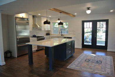 Eat-in kitchen - contemporary medium tone wood floor and brown floor eat-in kitchen idea in Baltimore with a single-bowl sink, recessed-panel cabinets, white cabinets, quartzite countertops, white backsplash, subway tile backsplash, stainless steel appliances, an island and white countertops