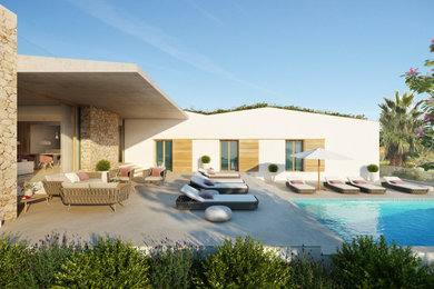 Diseño de terraza mediterránea grande en patio trasero y anexo de casas con zócalos, suelo de hormigón estampado y barandilla de vidrio