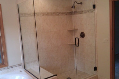Inspiration for a large beige tile and ceramic tile corner shower remodel in Detroit with beige walls