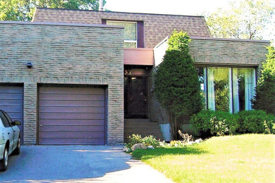 Large transitional two-story brick exterior home idea in Toronto with a shingle roof and a brown roof