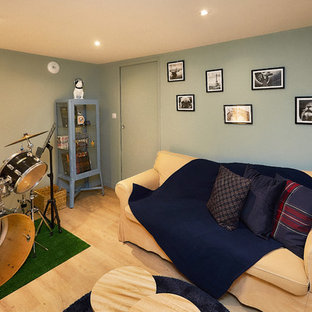 Small urban enclosed laminate floor and beige floor home theater photo in Dijon with green walls