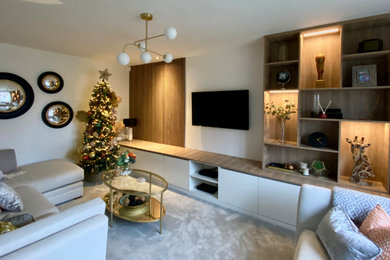 Photo of an enclosed living room in Other with white walls, carpet, a wall mounted tv and feature lighting.