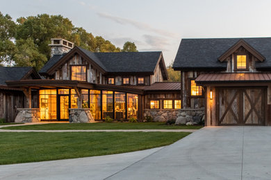 Inspiration for a large rustic brown two-story wood house exterior remodel in Other with a shingle roof and a black roof