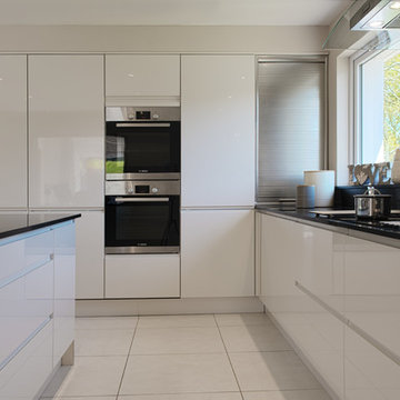 High Gloss Ivory kitchen with J/Intergral Handle and Tambour unit