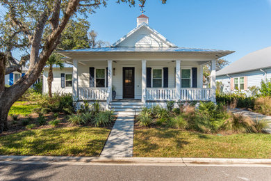 Inspiration for a white one-story house exterior remodel in Jacksonville with a metal roof