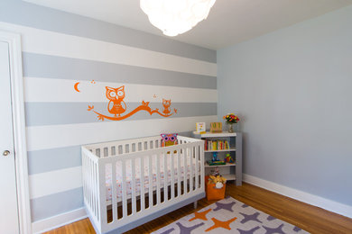 Example of a trendy boy nursery design in Los Angeles with gray walls