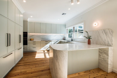Design ideas for a contemporary u-shaped kitchen in Sydney with a single-bowl sink, shaker cabinets, green cabinets, marble benchtops, light hardwood floors, brown floor and grey benchtop.