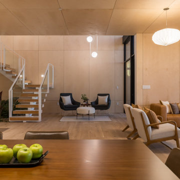 Evening interior with illuminated floating stair - Fold House Berkeley Hills