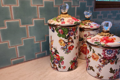 Example of a mid-sized transitional l-shaped ceramic tile and beige floor kitchen design in Other with an undermount sink, raised-panel cabinets, medium tone wood cabinets, quartz countertops, blue backsplash, ceramic backsplash, stainless steel appliances, an island and white countertops