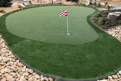Design ideas for a mid-sized contemporary backyard river rock landscaping in Denver.