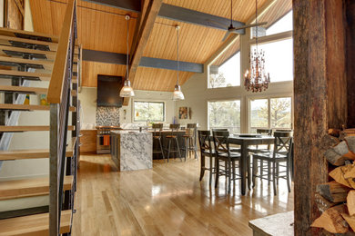 Arts and crafts light wood floor and brown floor kitchen photo in Denver with stainless steel appliances and an island