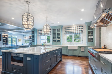 Example of a huge eclectic u-shaped dark wood floor open concept kitchen design in San Francisco with a farmhouse sink, beaded inset cabinets and an island