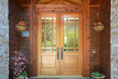 Example of an arts and crafts entryway design in San Francisco with a medium wood front door