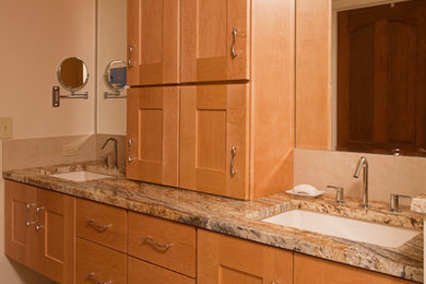 This is an example of a mid-sized contemporary 3/4 bathroom in Other with shaker cabinets, light wood cabinets, beige tile, stone tile, beige walls, travertine floors, an undermount sink and granite benchtops.