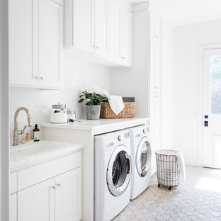 Photo of a classic utility room in Sacramento with a submerged sink, shaker cabinets, white cabinets, white walls, a side by side washer and dryer, multi-coloured floors and white worktops.