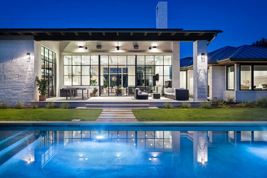 Example of a minimalist backyard rectangular pool design in Austin